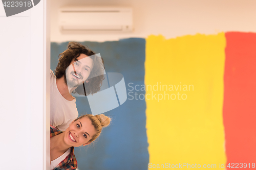 Image of portrait of a couple painting interior wall