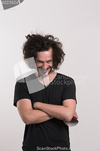 Image of Portrait of a man in party hat blowing in whistle