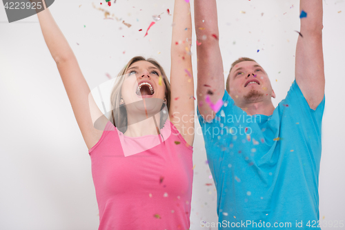 Image of romantic young  couple celebrating  party with confetti
