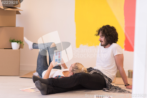 Image of Happy young couple relaxing after painting