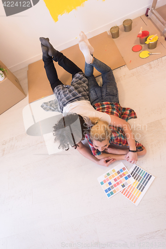 Image of Happy young couple relaxing after painting