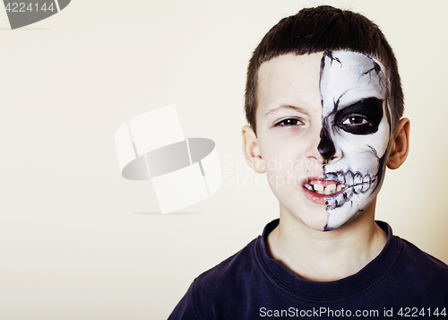 Image of little cute boy with facepaint like skeleton to celebrate hallow