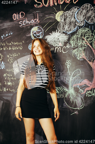 Image of young cute teenage girl in classroom at blackboard happy smiling, education people concept