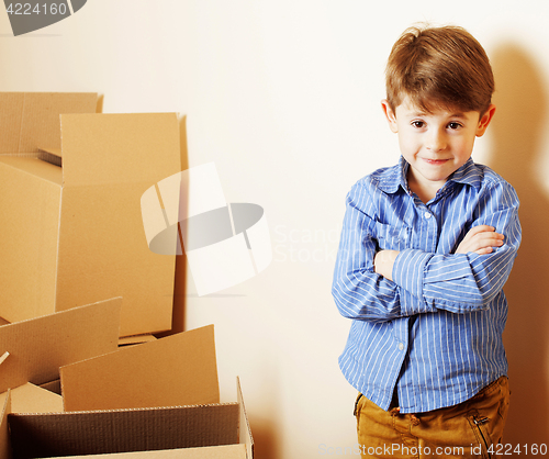 Image of little cute boy in empty room, remoove to new house. home alone,