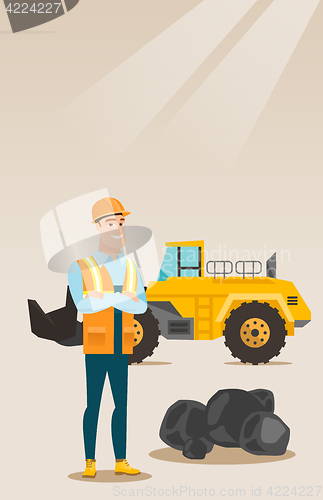 Image of Miner with a big excavator on background.