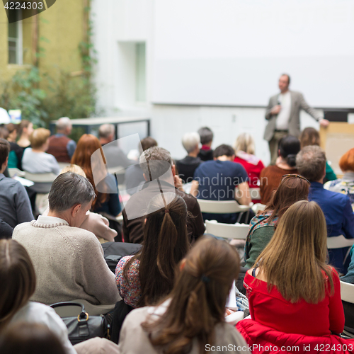 Image of Man giving presentation in lecture hall at university.