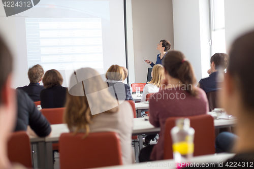 Image of Woman giving presentation in lecture hall at university.