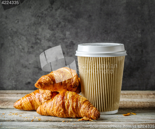 Image of cup of coffee and freshly baked croissants