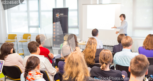 Image of Woman giving presentation on business conference.