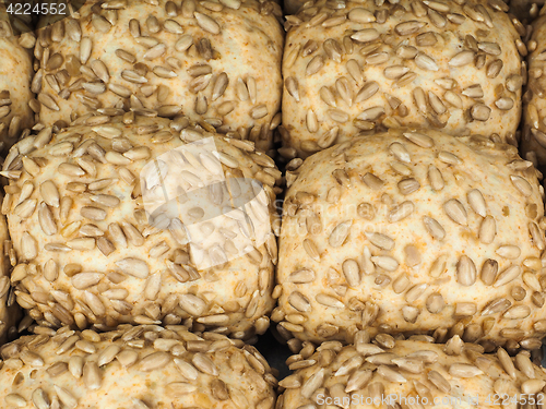 Image of Closeup of freshly made sunflower seed buns on a waxed paper tra