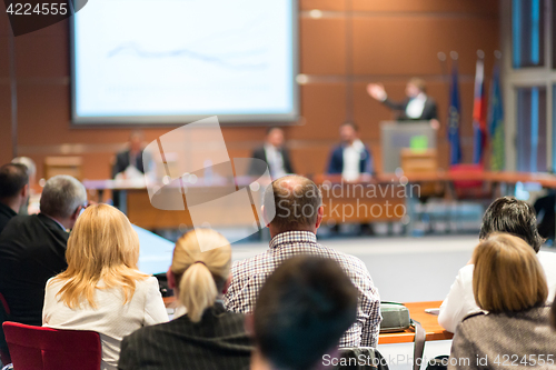 Image of Public speaker giving talk at business event.