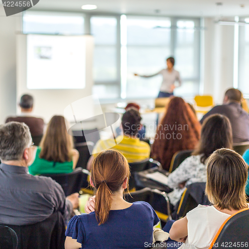 Image of Woman giving presentation on business conference.