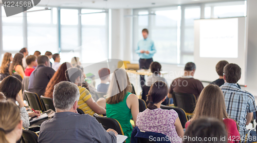 Image of Speaker giving presentation on business conference.