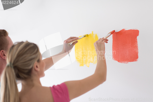 Image of couple painting interior wall