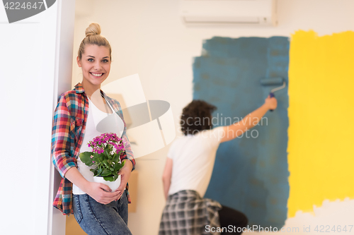 Image of happy young couple doing home renovations