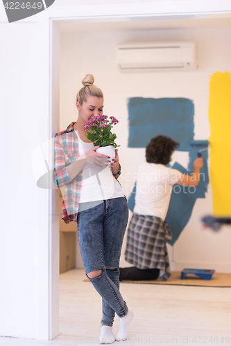 Image of happy young couple doing home renovations