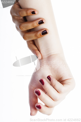 Image of two different nathion manicured hands on white isolated, african