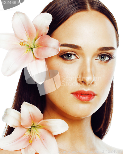 Image of young attractive lady close up with hands on face isolated flowe