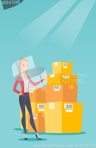 Image of Business woman checking boxes in warehouse.