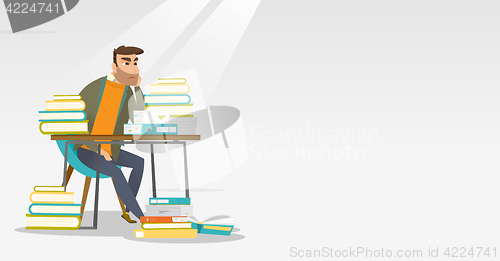 Image of Student sitting at the table with piles of books.