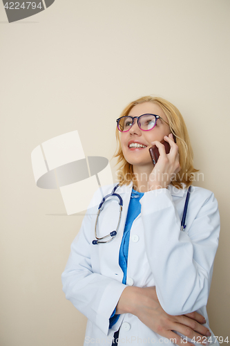 Image of Young doctor talking on phone