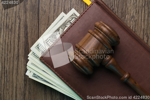 Image of Wooden table with hammer, dollars