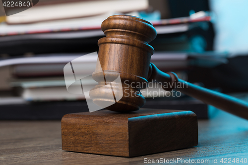 Image of Wooden table with hammer, documents