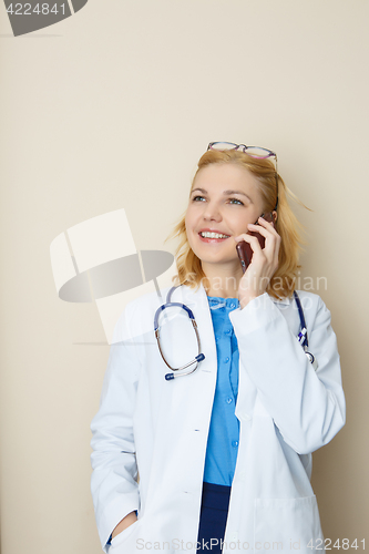 Image of Young blonde talking on phone