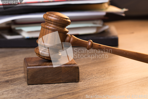 Image of Documents, hammer on wooden table