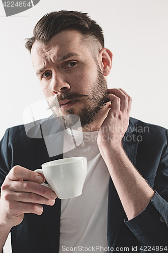 Image of Portrait of stylish handsome young man with cup of coffee