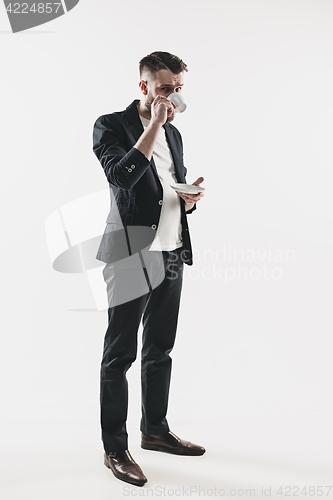 Image of Portrait of stylish handsome young man with cup of coffee