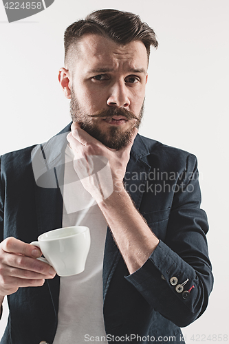 Image of Portrait of stylish handsome young man with cup of coffee