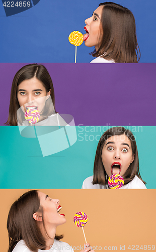 Image of young woman with the colorful lollipop at studio