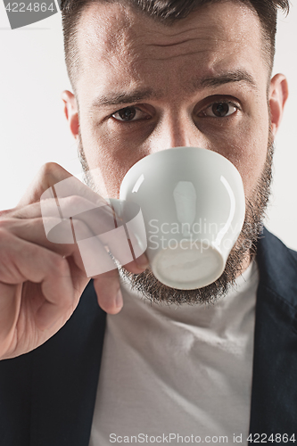 Image of Portrait of stylish handsome young man with cup of coffee