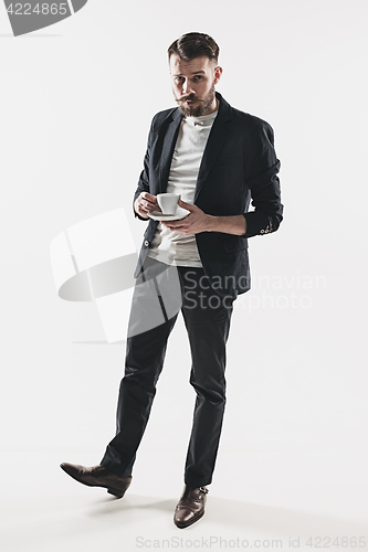 Image of Portrait of stylish handsome young man with cup of coffee