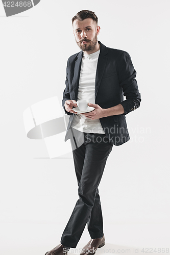 Image of Portrait of stylish handsome young man with cup of coffee