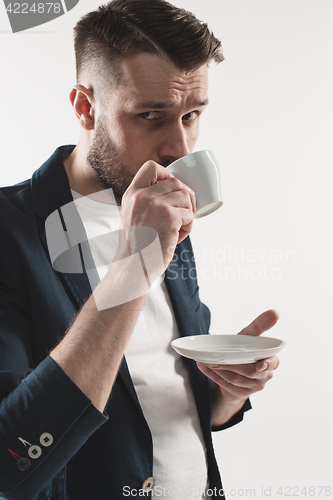 Image of Portrait of stylish handsome young man with cup of coffee