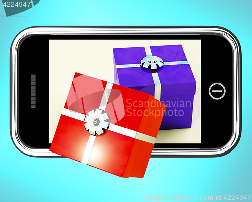 Image of Gift Boxes Coming From Mobile Phone Shows Buying Presents Online