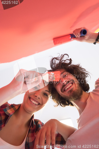 Image of couple painting interior wall