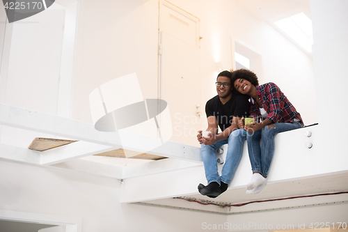 Image of couple having break during moving to new house