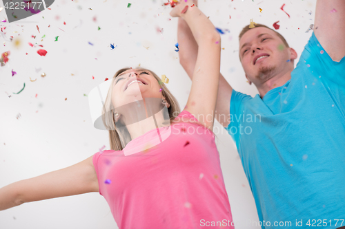 Image of romantic young  couple celebrating  party with confetti