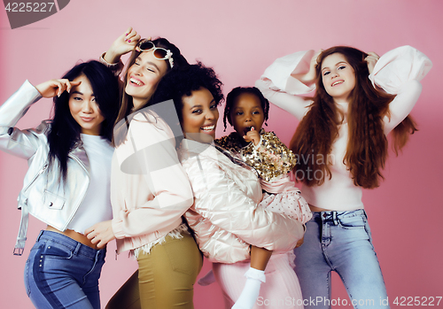 Image of three different nation girls with diversuty in skin, hair. Asian, scandinavian, african american cheerful emotional posing on pink background, woman day celebration, lifestyle people concept 