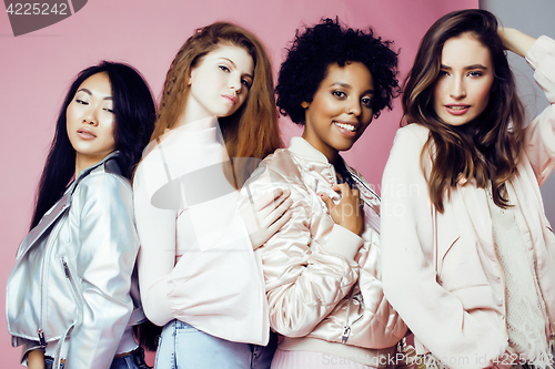 Image of three different nation girls with diversuty in skin, hair. Asian, scandinavian, african american cheerful emotional posing on pink background, woman day celebration, lifestyle people concept 