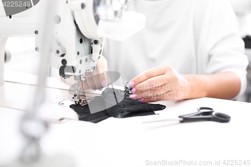 Image of Constructor. Sewing on a machine.  Sewing machine 