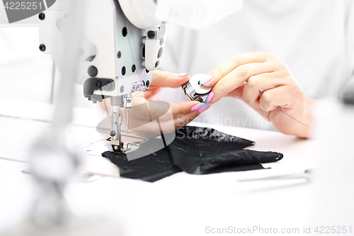 Image of Factory, sewing room. Production of apparel. Occupation needlewoman.