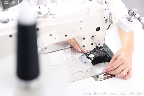 Image of Constructor. Sewing on a machine.  Sewing machine  Sewing. Sewing machine 