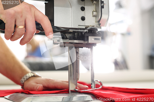 Image of Cutting room, cutting cloth tailoring knife. 