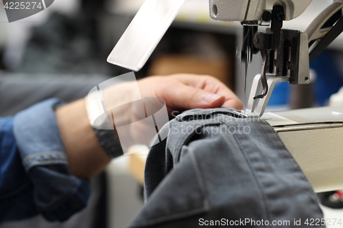 Image of Sewing. Factory, sewing room. Production of apparel. Occupation needlewoman.