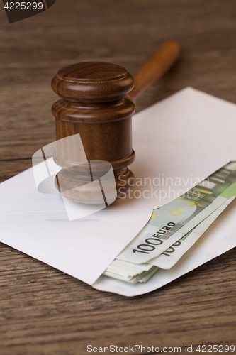 Image of Wooden table with hammer, bills