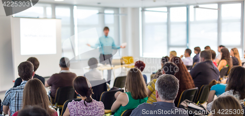 Image of Speaker giving presentation on business conference.